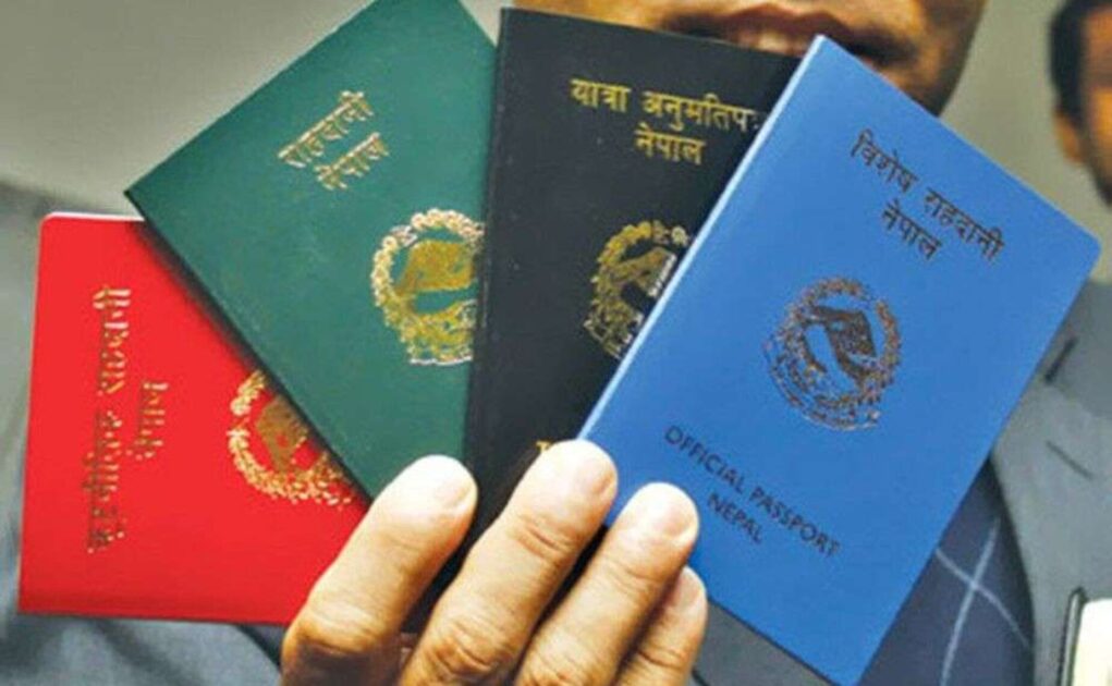four nepalese passports in a person's hand