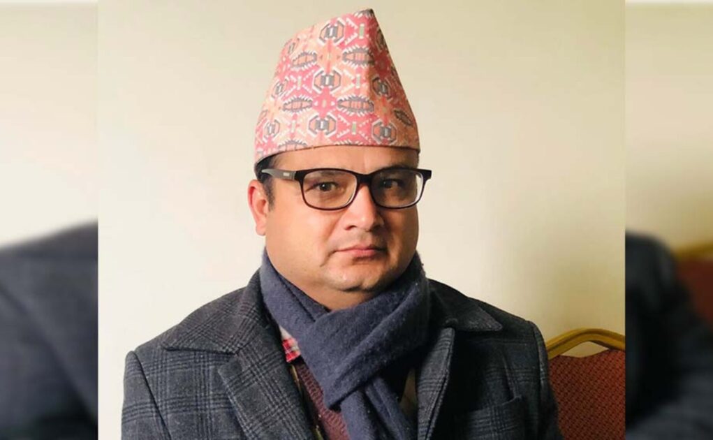 A man wearing Nepali cap and glasses.