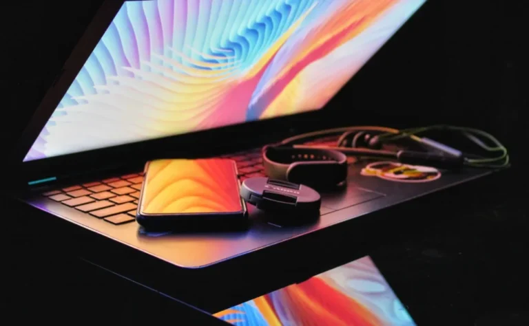 phones and speakers kept above the laptop keyboard