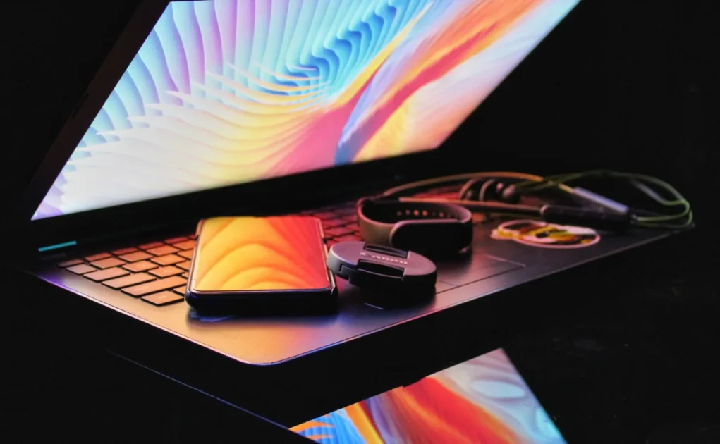 phones and speakers kept above the laptop keyboard