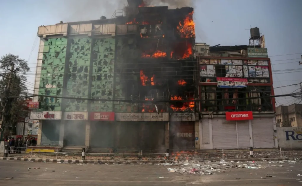 a building on fire during protest in tinkune